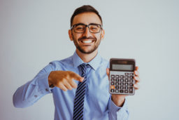 Man holding a calculator.