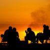 Group sitting on a sunset