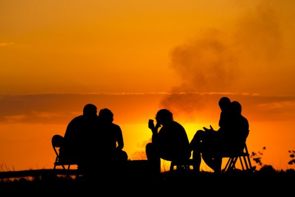 Group sitting on a sunset